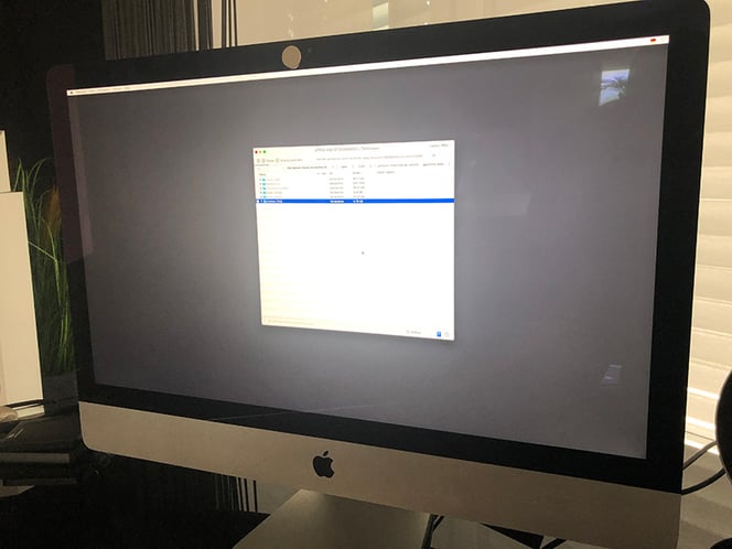 An iMac powered up and displaying information about its storage and hard drives