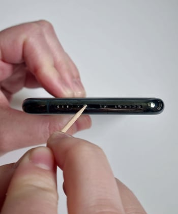 Insert a toothpick into the charging port to loosen debris.